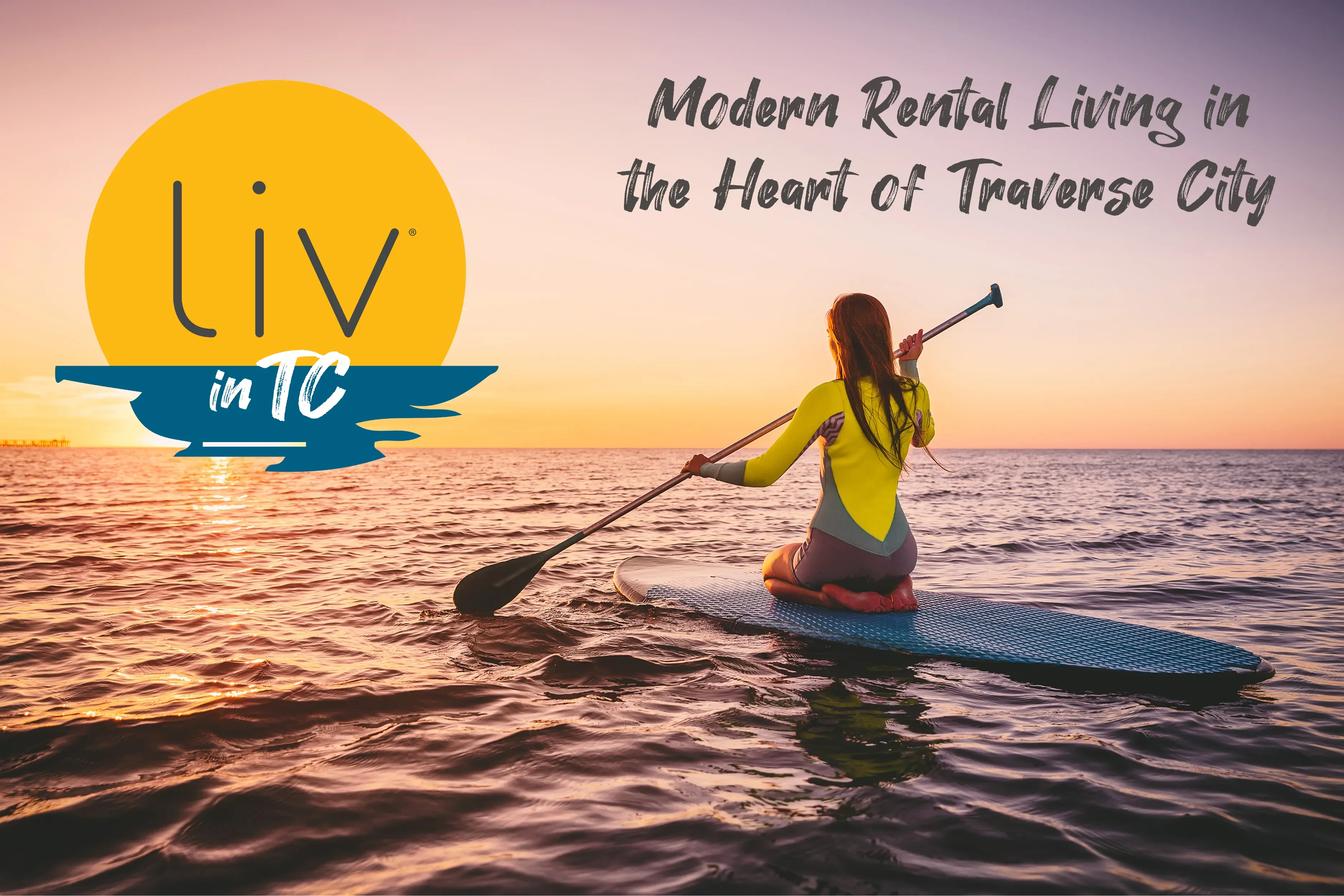 Person kneeling on a paddleboard at sea, paddling toward the horizon during a colorful sunset